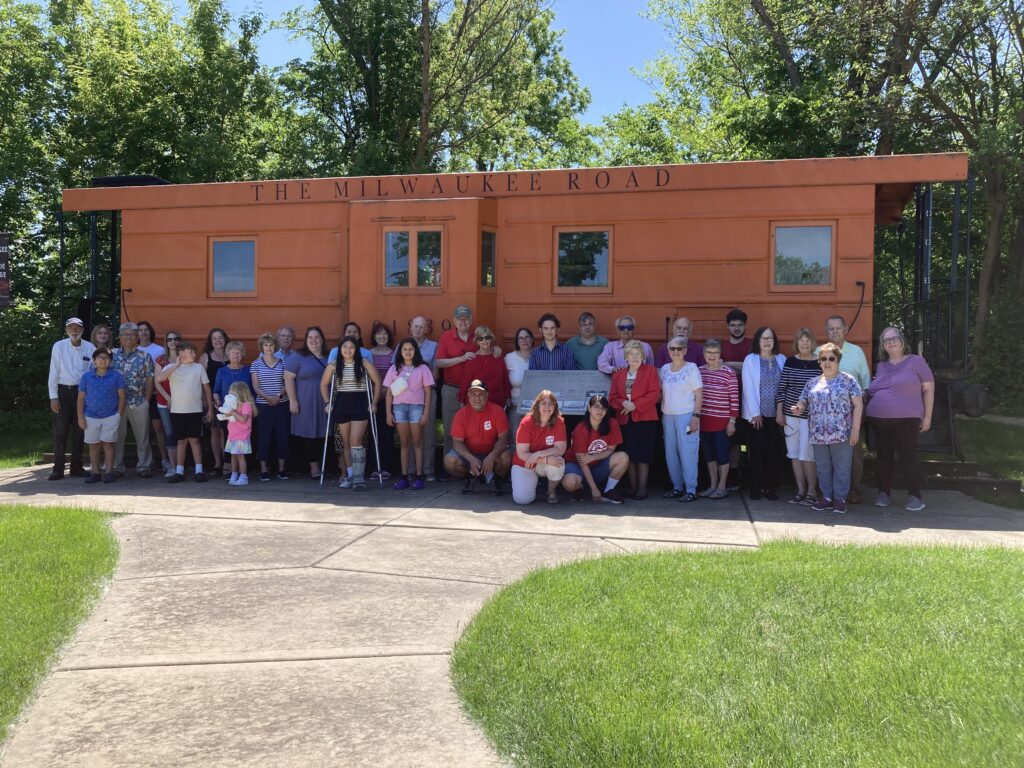 FPC Itasca meets at the “train” in the Itasca park district for worship and to take a photo of the congregation. The photo commemorates a photo taken back in about 1883 in front of the railroad car where the Sunday School first met.